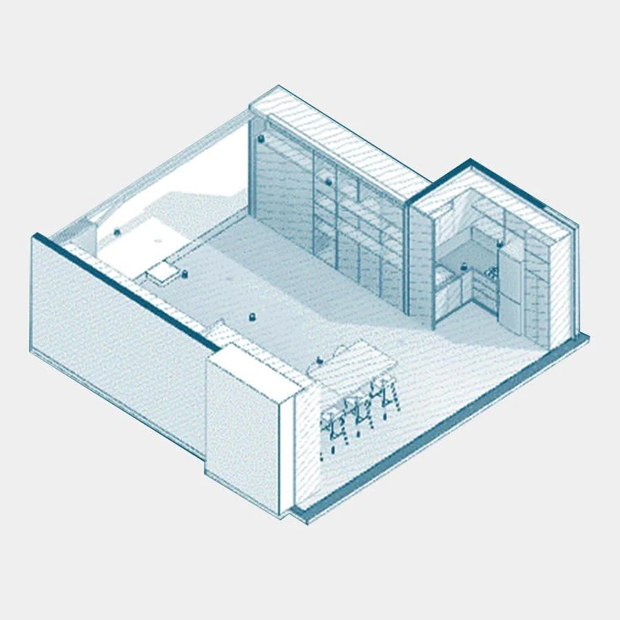 The service band: a floor-to-ceiling archive running along an entire wall and an L-shaped kitchen at the back, concentrating everything the office needs to store into a single strip.