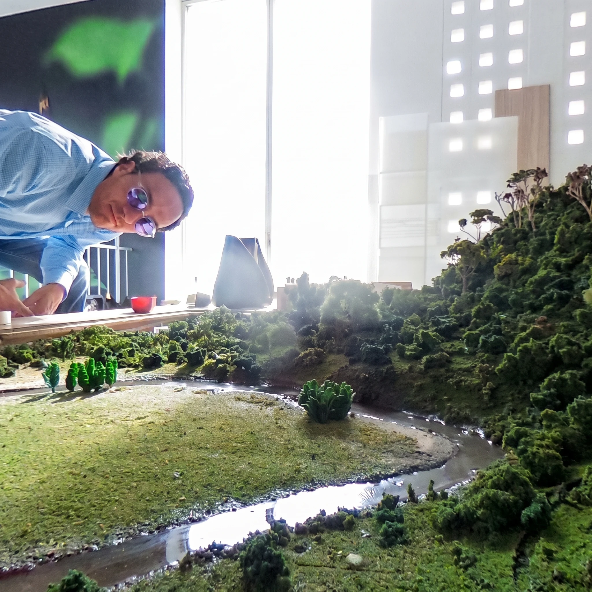 The physical site model, with the watercourse and the woodland modelled, used to verify how the piece reads from the city.