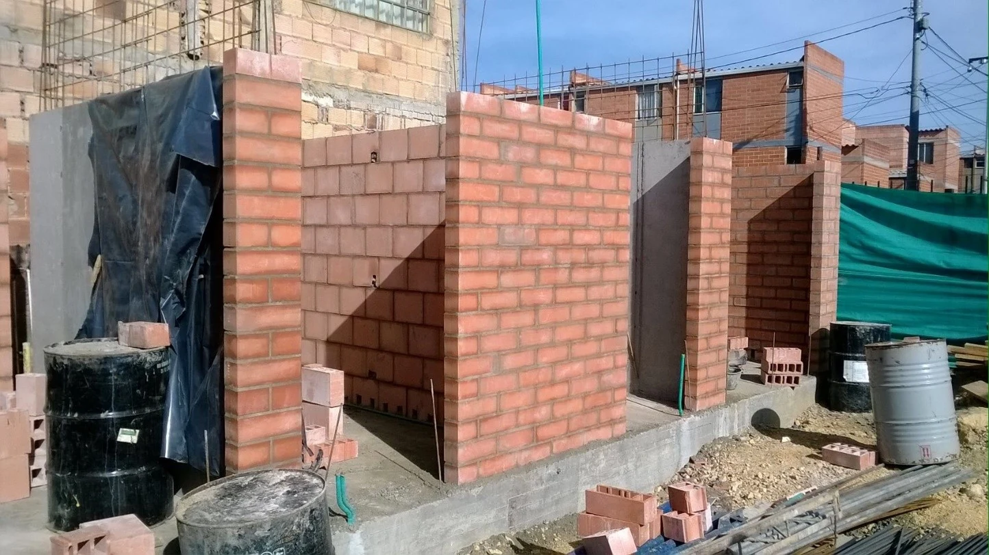 Progress of the structural brick masonry, with the window openings already defined toward the facade.